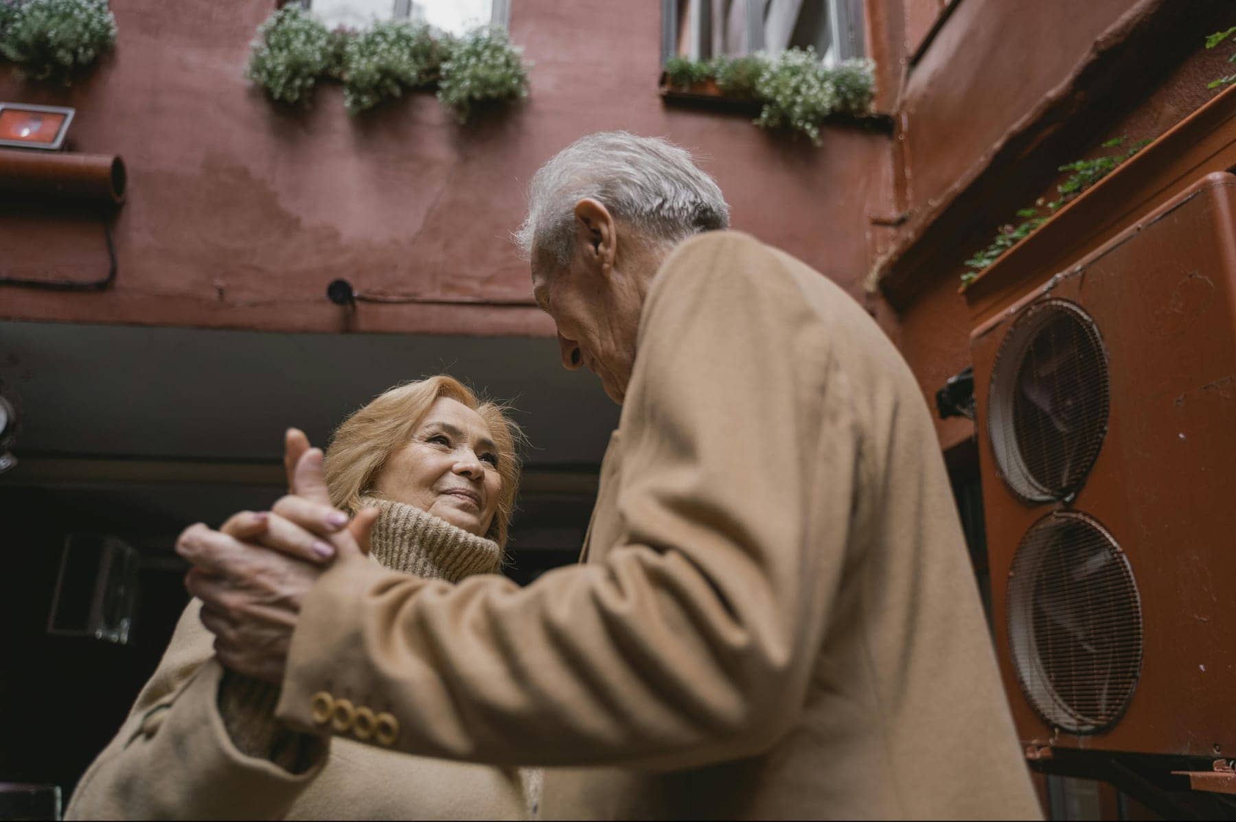 An older couple dancing together, familiar movement with a partner close