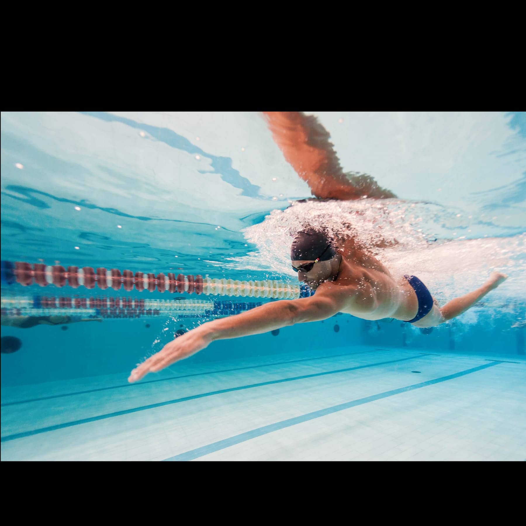 A swimmer mid-stroke, building endurance at a steady, unhurried effort
